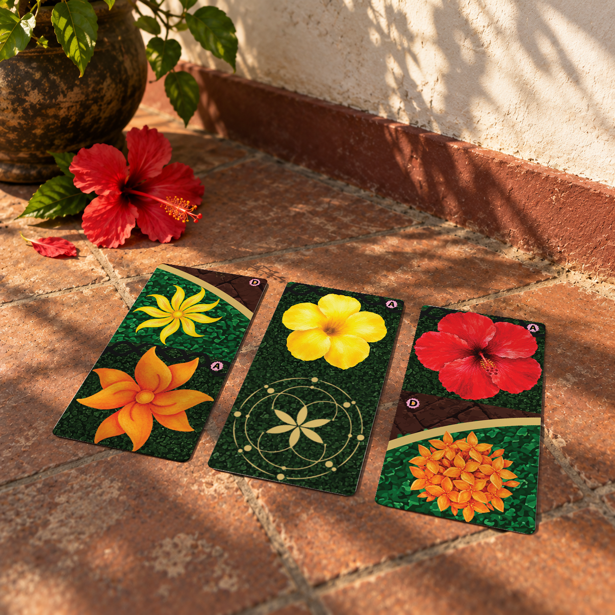 Pookalam board game box with colourful flower carpet design on a bright green leaf